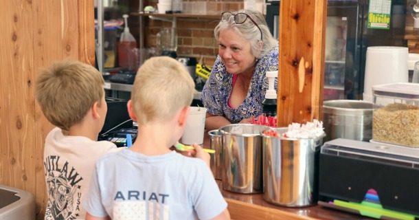 Two young boys buy ice cream from the owner of Sandhills Ice Cream and Treats in Valentine, Nebraska, in May 2023. (Russell Shaffer/Rural Prosperity Nebraska)