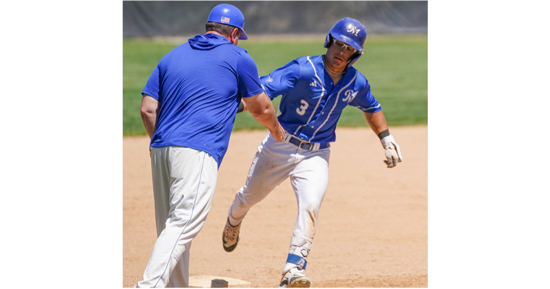 Maddox Shaver is congratulated at third base by Coach Jon Olsen after hitting a home run – one of five hits Shaver had on the day.